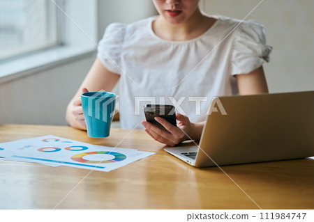 Young woman with smartphone and coffee Young woman with smartphone and coffee 111984747