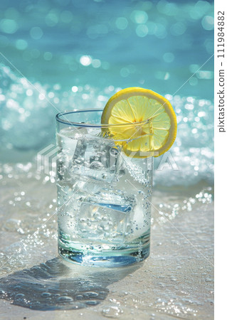 Cold drink with ice and a slice of lemon on the beach on a hot summer day. Ai generative 111984882