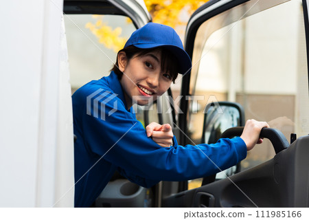 A female truck driver checks the safety of her surroundings by pointing and calling. A female truck driver checks the safety of her surroundings by pointing and calling. 111985166
