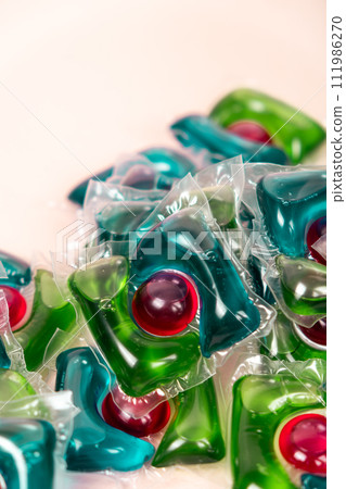 Laundry capsules on beige background close-up Laundry capsules on beige background close-up 111986270