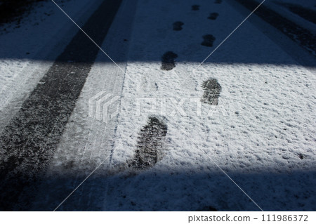 footprints and shadows on the snow footprints and shadows on the snow 111986372