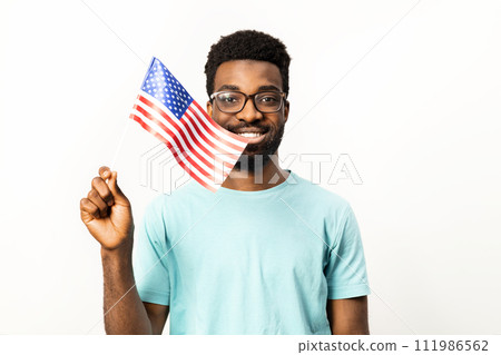 Smiling African American Man Holding American Flag Isolated on White 111986562