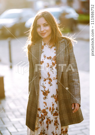 Attractive woman walking on the city street, relaxing on sunny day, Spring girl. Lifestyle concept. Attractive woman walking on the city street, relaxing on sunny day, Spring girl. Lifestyle concept. 111986752