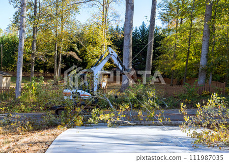 Tree chaos after hurricane uprooted, fallen near home, street cleaned up raised with tractor Tree chaos after hurricane uprooted, fallen near home, street cleaned up raised with tractor 111987035