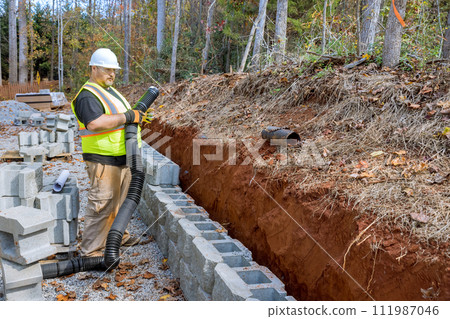 Process of laying drainage pipe for rainwater in retaining wall to prevent water buildup. Process of laying drainage pipe for rainwater in retaining wall to prevent water buildup. 111987046