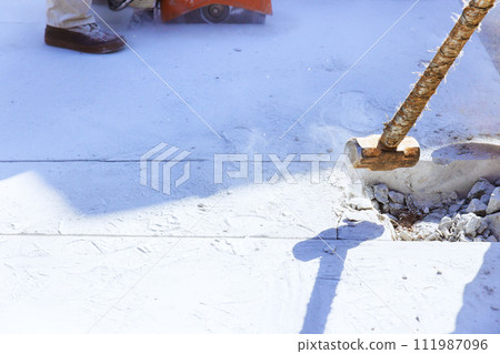 Concrete old driveway breaking worker demolished using hammer on construction site 111987096