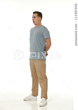 surprised guy looking at camera on white studio background 111987856