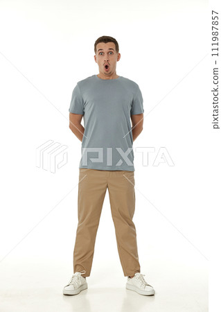 surprised guy looking at camera on white studio background 111987857