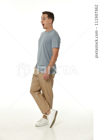 surprised guy looking at camera on white studio background 111987862
