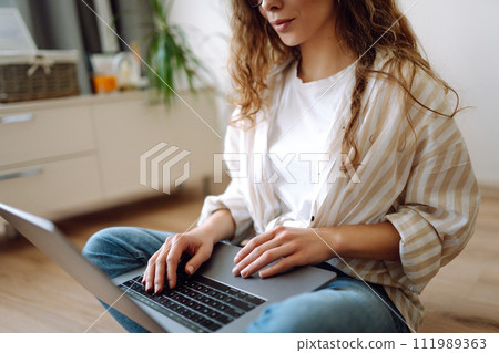 Close-up of woman's hands on a laptop keyboard, typing on modern laptop at home. Freelancing concept 111989363