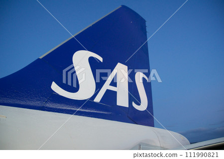 COPENHAGEN, DENMARK - NOV 24, 2018: View of the blue SAS Scandinavian Airlines logo on the tail unit of the Airbus A320 during boarding via the rear door 111990821