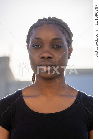 Calm Young African Woman in Soft Sunlight Calm Young African Woman in Soft Sunlight 111990887
