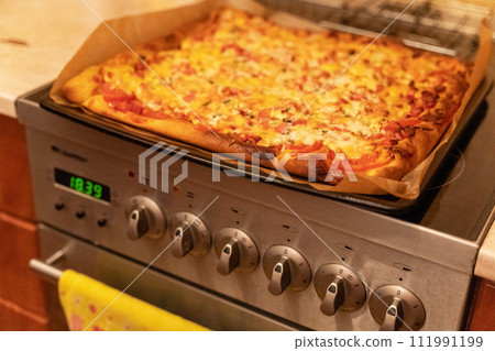 Scrumptious pizza with melting cheese, slices of sausage, and fresh cucumbers Scrumptious pizza with melting cheese, slices of sausage, and fresh cucumbers 111991199