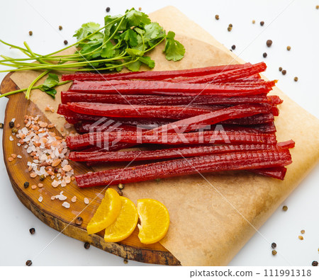 Smoke salmon on craft paper at wooden table. Tenderloin fish still life. Country meal. 111991318