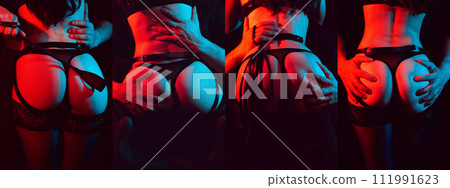 BDSM couple sex. A dominant man with a flogger whip holds in hands the sexy ass of a submissive woman bottom girl with a neon light 111991623