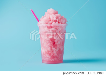 Pink crushed ice slushy in a clear cup with a straw, set against a complementary blue background Pink crushed ice slushy in a clear cup with a straw, set against a complementary blue background 111991980