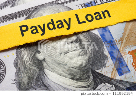Payday loan concept. A strip of paper lies on the dollars. Payday loan concept. A strip of paper lies on the dollars. 111992194
