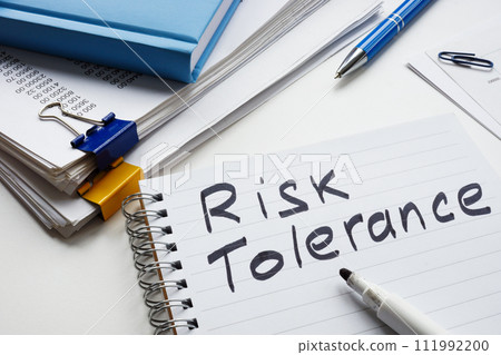 Handwritten inscription risk tolerance in a business notepad. 111992200