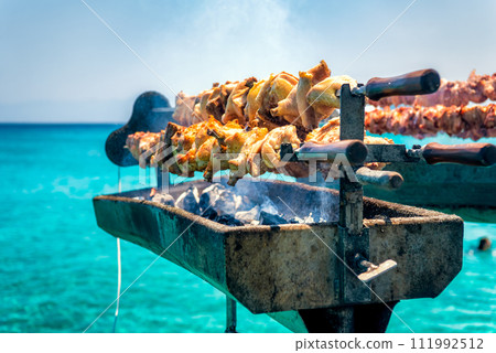 Cooking fresh Cypriot souvla on the sea Cooking fresh Cypriot souvla on the sea 111992512