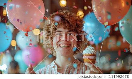 Joyful Woman Celebrating with Balloons and Cupcake 111992678