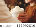 AI-generated content. White beautiful cup with a hot drink and whipped cream in children's hands 111992810