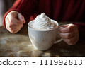 AI-generated content. White beautiful cup with a hot drink and whipped cream in children's hands 111992813