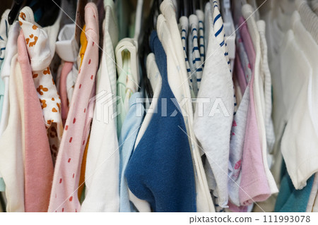 Children clothes hanging on hangers in the shop Children clothes hanging on hangers in the shop 111993078