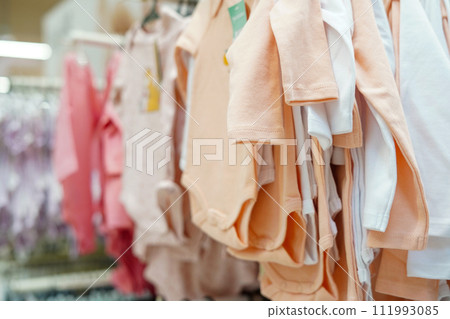 Baby clothes hanging on hangers in the shopping mall 111993085