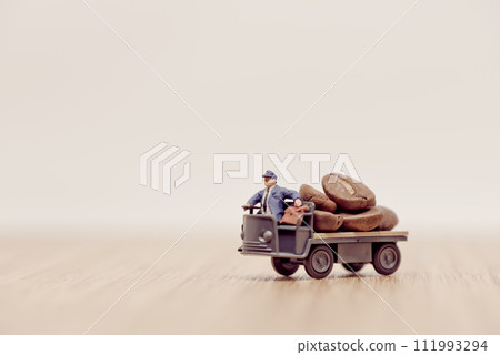 Miniature toy truck loaded with brown coffee beans Miniature toy truck loaded with brown coffee beans 111993294