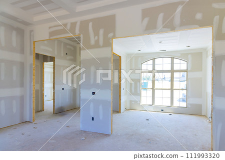 Building new home with gypsum plaster walls drywall that has been finished in preparation for painting 111993320