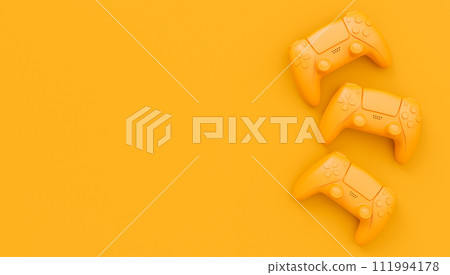 Video game joysticks or gamepads in plain monochrome yellow color background 111994178