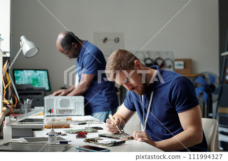 Bending over computer motherboard 111994327