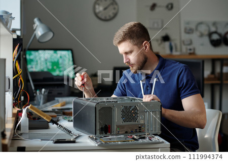 Young serious male technician at work 111994374
