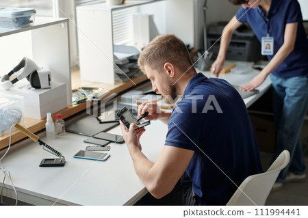 Young worker of technical repair office 111994441