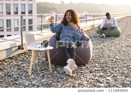 African American blogger demonstrating city view for subscribers. 111994804