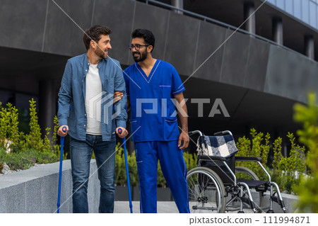 Male nurse helping a patient with disability Male nurse helping a patient with disability 111994871
