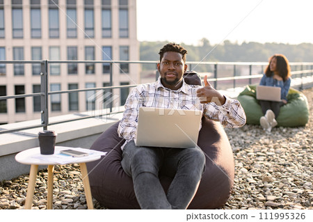 African American male freelancer using portable computer. 111995326