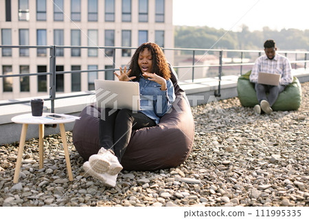 African female freelancer beginning video conference via internet connection. African female freelancer beginning video conference via internet connection. 111995335