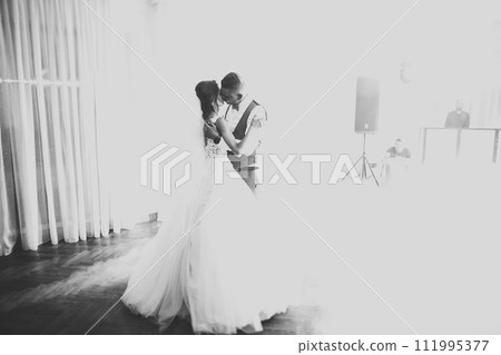 Beautiful wedding couple just married and dancing their first dance 111995377