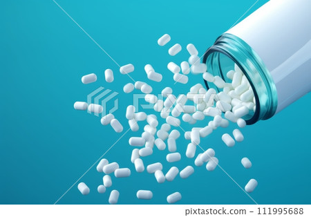 pills fall from a bottle onto a blue background 111995688