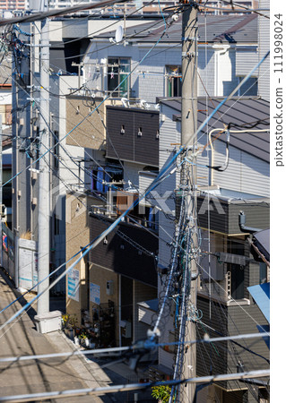 Japanese residential area lined with utility poles Japanese residential area lined with utility poles 111998024