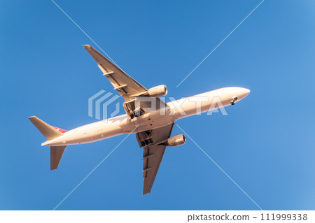 Airplane before landing in blue sky, Airbus A330 111999338
