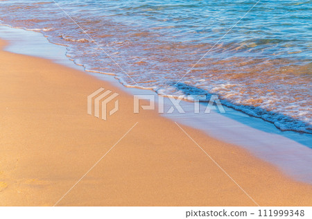 Soft wave of the sea on the sandy beach. 111999348
