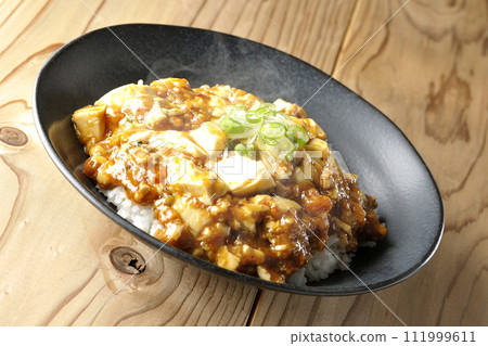 Piping hot mapo bowl topped with plenty of tofu and green onion Piping hot mapo bowl topped with plenty of tofu and green onion 111999611