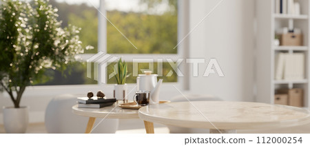 A copy space for product display on a marble coffee table in a modern white living room. 112000254