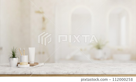 Toiletries and empty space on a white marble tabletop with a blurred background of a luxury bathroom Toiletries and empty space on a white marble tabletop with a blurred background of a luxury bathroom 112000258