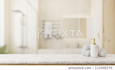 Toiletries and empty space on a white marble tabletop in a modern bright and clean bathroom. 112000259