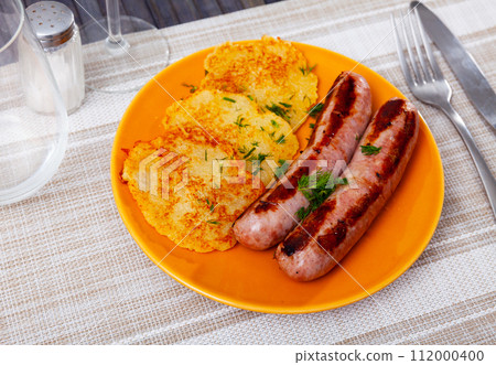 National dish of Belarusian cuisine is draniki with fried sausages 112000400