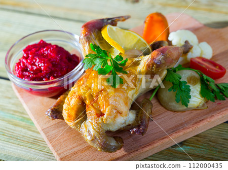 Grilled hen with cranberry sauce and broiled vegetables Grilled hen with cranberry sauce and broiled vegetables 112000435