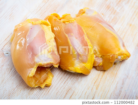 Raw chicken breast on wooden table 112000482